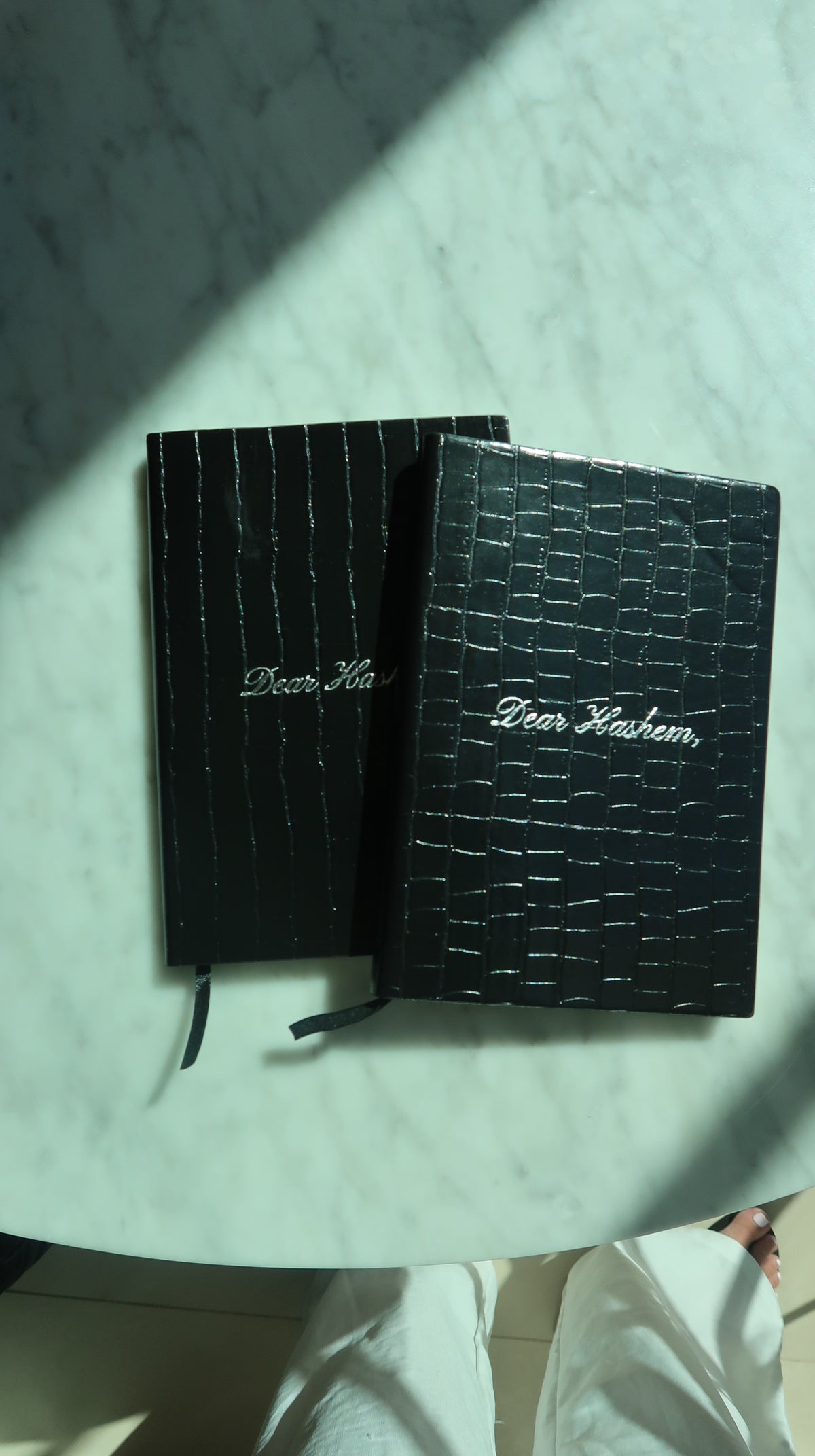Two Layla Dear Hashem Journals showing the black crocodile-texture covers